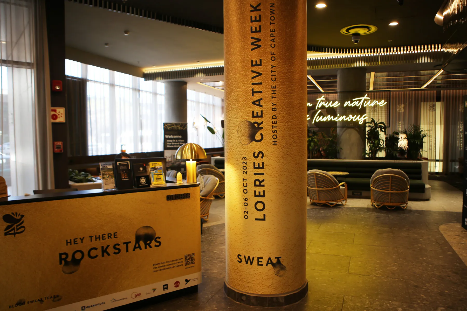 Branded pillar and bar at a Creative Week venue